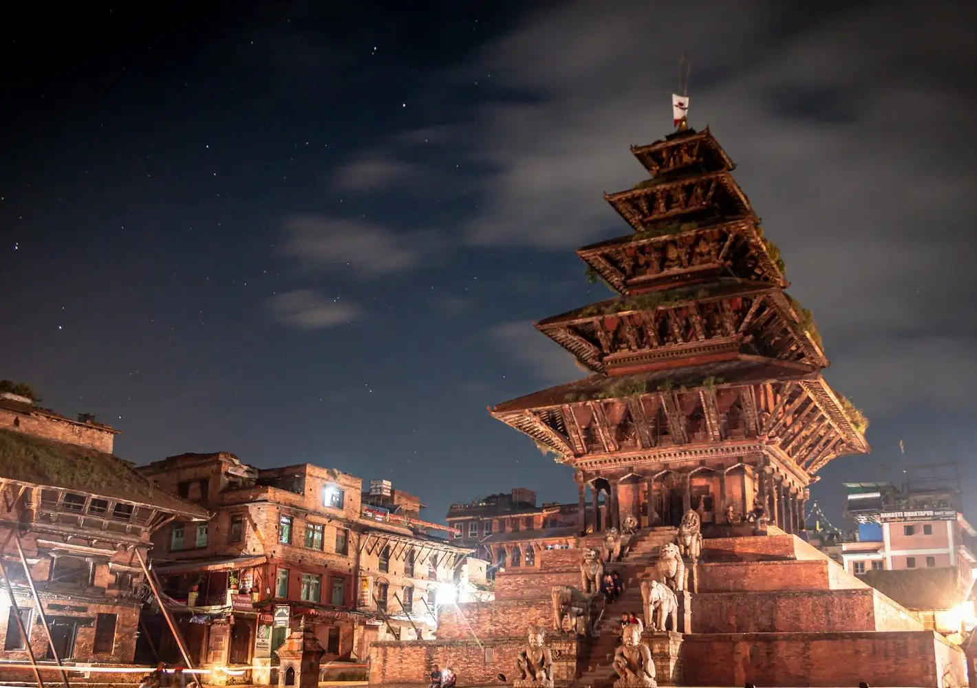 A Nepali pagoda temple lit against a night sky